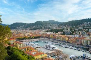a city with boats docked in a harbor at Le Campus Appartement in Nice