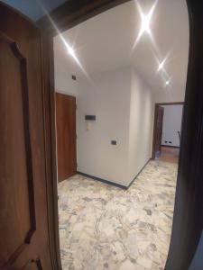 a hallway with a room with a tile floor at SWEET HOUSE dolce casa in Campomorone