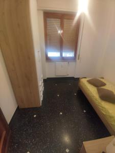 an empty room with two beds and a window at SWEET HOUSE dolce casa in Campomorone +1 photo