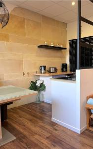 a kitchen with a table and a counter top at Appartement, Nature, Relaxation et Demi-Pension Possible in Crévic +50 photos