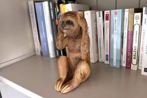 a statue of a stuffed bear sitting on a book shelf at Appartement, Nature, Relaxation et Demi-Pension Possible in Crévic