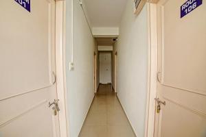 a hallway with two doors and a long corridor at Hotel O Fortuner Palace in Bengaluru