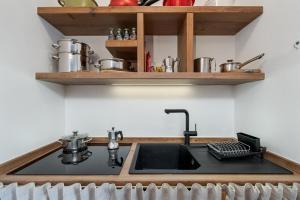 a kitchen with a sink and a counter top at Appartamento Vittoria in Cavalese