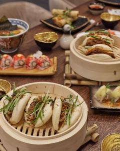 a wooden table with plates of food on it at Bor Hotel by Karisma in Zlatibor +52 photos