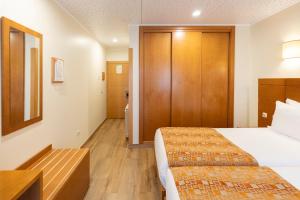 Uma cama ou camas num quarto em Hotel Berne