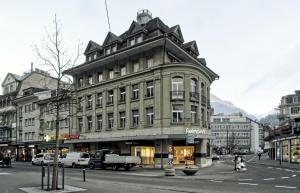 a large building on the corner of a city street at BANK House Studio L 205 - GRIWA RENT in Interlaken