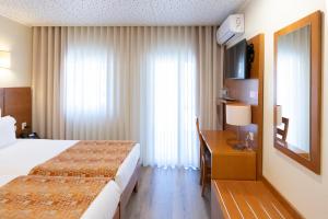 Uma cama ou camas num quarto em Hotel Berne