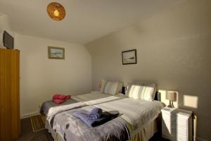a bedroom with a bed with towels on it at Kavija, Invergordon in Invergordon +28 photos