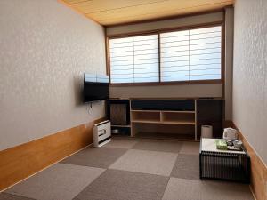 a living room with a large window and a room with at Zao Sunvalley Hotel in Yamagata +28 photos