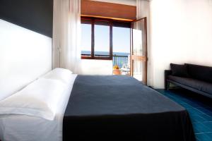 Postel nebo postele na pokoji v ubytování Hotel La Playa
