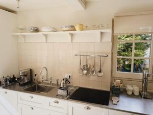 a kitchen counter with a sink and a window at Le Cottage du Lignon - Lumineuse Elégante Calme WiFi in Le Chambon-sur-Lignon +66 photos