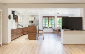 a kitchen and dining room with a large flat screen tv at Apartament nad Dzikim Potokiem in Karpacz