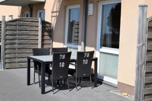 a table and chairs sitting on a patio at Fehmarnstrand 78 App 10 in Staberdorf +4 photos