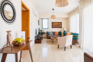 a living room with a table and a couch at CityDen in Larnaka