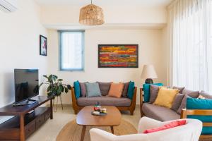 a living room with two couches and a table at CityDen in Larnaka