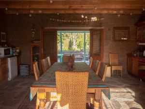a dining room with a wooden table and chairs at Murrayfield Karoo Guest Villa in Nieu-Bethesda