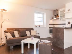a living room with a couch and a table at Ferienwohnung Julian in Hörnum