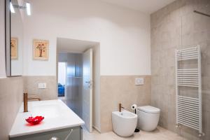 a white bathroom with a sink and a toilet at La Casa di Nena - San Miniato in San Miniato +39 photos