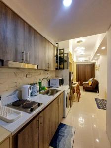 a kitchen with a sink and a stove top oven at S Residences 942b near airport pasay in Manila