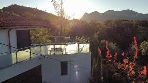 a balcony of a house with a view of the mountains at Villa Lucitello by Monarca Location, refuge Familial à 10 minutes de Saint Florent in Barbaggio