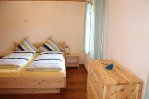 a bedroom with a wooden bed and a window at Naturhaus Altmuehltal in Titting
