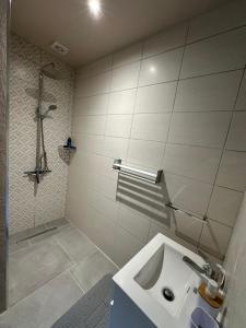 a white bathroom with a sink and a shower at Naturehome Avô in Avô