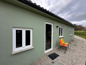 a green house with two chairs in front of it at Naturehome Avô in Avô