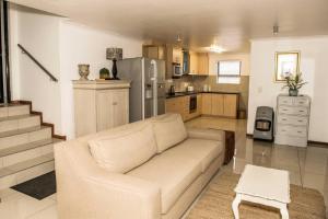a living room with a couch and a kitchen at The Views - Oceanview Haven in Langebaan - 3 Levels of Luxury in Langebaan