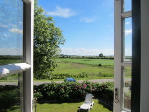 a view of a field from a window at Nordseekrabbe 12 Herrenhof in Wrixum