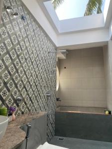 a bathroom with a shower and a sink and a window at Casa Nauka in Colva +22 photos