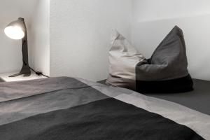 a bed with a pillow and a lamp in a room at Ferienwohnung Ohechaussee in Norderstedt +55 photos