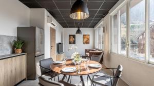 a kitchen and dining room with a table and chairs at Le Dauphine 3 Allevard in Allevard
