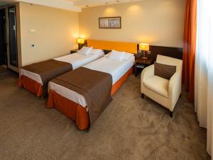 Postel nebo postele na pokoji v ubytování Abacus Business & Wellness Hotel