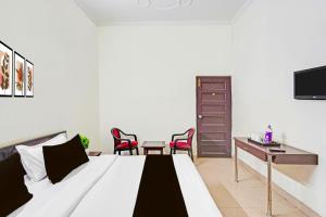 Katil atau katil-katil dalam bilik di Super Collection O Race Course Dehradun