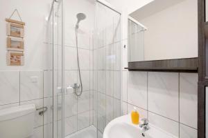 a bathroom with a shower and a toilet and a sink at Ferienwohnung Laage in Laage +11 photos