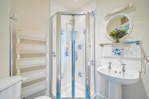 a bathroom with a shower and a sink at Flat 1 The Salcombe in Salcombe