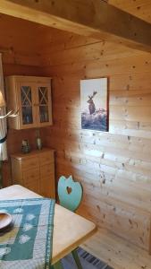 a bedroom in a log cabin with a deer picture on the wall at Blockhaus Stamsried in Stamsried