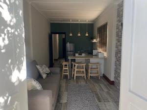 a living room and kitchen with a couch and a table at Te Môi in Paarl +8 photos
