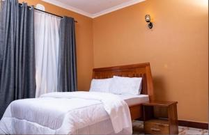 a bedroom with two beds and a window at MSF one bedroom in Arusha