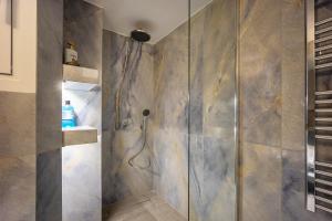 a bathroom with a shower with a glass door at Elegant Aphrodite, 2 Bedroom Apartment, by Acropolin in Athens +29 photos