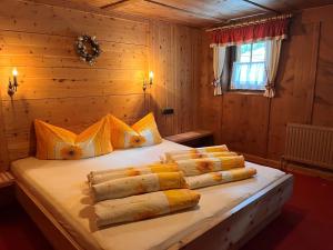 a bedroom with a large bed with yellow and white pillows at Chalet Hannelore-3 by Interhome in Sölden