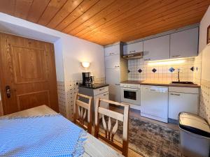 a small kitchen with a bed and a table at Chalet Hannelore-3 by Interhome in Sölden