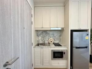 a dog is sitting on a counter in a kitchen at DLUX 7TH Floor in Ban Klang