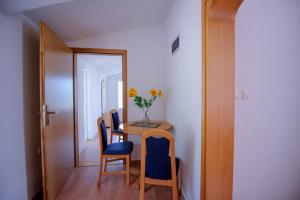 a dining room with a table and chairs and a mirror at Vila Maric in Brist