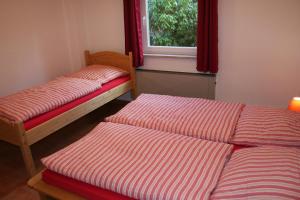 a room with two twin beds and a window at Ferienhaus Maria Magdalena in Bad Lauterberg