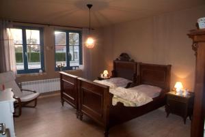 a bedroom with a bed and a chair and windows at Auszeit am Haff in Vogelsang +6 photos
