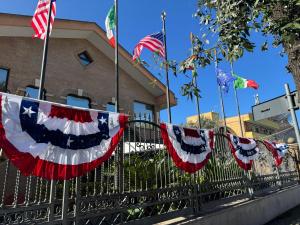 a fence with american flags on it at EURO HOUSE INN airport in Fiumicino
