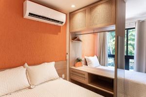 a small bedroom with two beds and a window at Paraíso familiar em frente a vila do pescador caboclo na nova orla de Tamandaré in Tamandaré +41 photos