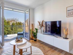 a living room with a large tv and a large window at Bernsteinquartier BQ 0108 in Kolpinsee