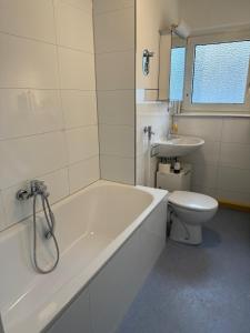 a bathroom with a tub and a toilet and a sink at Monteur- und Ferienwohnung Landau - Südliche Weinstraße in Landau in der Pfalz